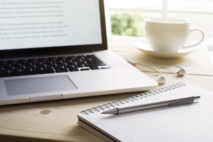 a laptop and notebook used for seo content writing services